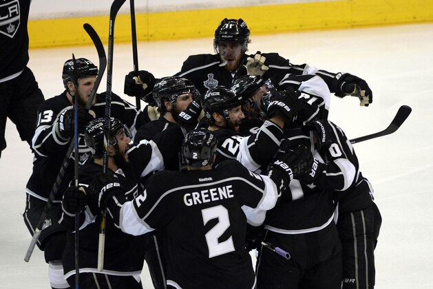 Jun 4, 2014; Los Angeles, CA, USA; Los Angeles Kings right wing Justin Williams (14) is congratulated by teammates after scoring the game-winning goal in the overtime period during game one of the 2014 Stanley Cup Final against the New York Rangers at Staples Center. Mandatory Credit: Richard Mackson-USA TODAY Sports