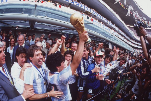JUL 1986:  DIEGO MARADONA OF ARGENTINA LIFTS THE WORLD CUP TROPHY IN FRONT OF THE WORLD's MEDIA AFTER ARGENTINA BEAT GERMANY 3-2 TO WIN  THE 1986 SOCCER WORLD CUP FINAL. Mandatory Credit: Allsport UK/ALLSPORT
