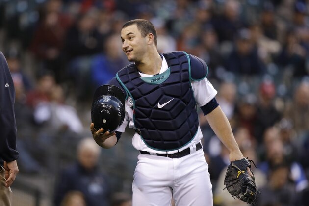 Seattle Mariners catcher Mike Zunino smiles after being checked on during a baseball game against the Los Angeles Angels Thursday, May 29, 2014, in Seattle. (AP Photo/Elaine Thompson)