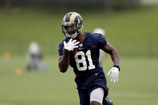 St. Louis Rams wide receiver Kenny Britt runs with the ball during an organized team activity at the NFL football team's practice facility Thursday, June 5, 2014, in St. Louis. (AP Photo/Jeff Roberson)