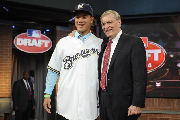 Baseball commissioner Bud Selig, right, poses with pitcher Kodi Medeiros from Waiakea High School in Hilo, Hawaii, who was selected by the Milwaukee Brewers with the 12th selection in the 2014 MLB baseball draft Thursday, June 5, 2014, in Secaucus, N.J. (AP Photo/Bill Kostroun)