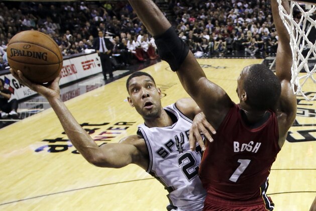 San Antonio Spurs forward Tim Duncan (21) shoots over Miami Heat center Chris Bosh (1) during the first half in Game 1 of the NBA basketball finals on Thursday, June 5, 2014, in San Antonio. (AP Photo/Eric Gay, Pool)
