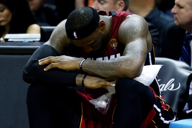 SAN ANTONIO, TX - JUNE 05:  LeBron James #6 of the Miami Heat sits on the bench after leaving the game in the fourth quarter with cramps against the San Antonio Spurs during Game One of the 2014 NBA Finals at the AT&T Center on June 5, 2014 in San Antonio, Texas. NOTE TO USER: User expressly acknowledges and agrees that, by downloading and or using this photograph, User is consenting to the terms and conditions of the Getty Images License Agreement.  (Photo by Andy Lyons/Getty Images)