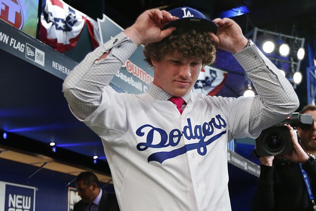 SECAUCUS, NJ - JUNE 5: Grant Holmes puts on his Los Angeles Dodgers cap after being selected 22nd overall during the MLB First-Year Player Draft at the MLB Network Studio on June 5, 2014 in Secacucus, New Jersey. (Photo by Rich Schultz/Getty Images)