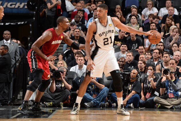 SAN ANTONIO, TX - JUNE 05: Tim Duncan #21 of the San Antonio Spurs handles the basketball against Chris Bosh #1 of the Miami Heat during Game One of the 2014 NBA Finals between the Miami Heat and San Antonio Spurs at AT&T Center on June 5, 2014 in San Antonio, Texas. NOTE TO USER: User expressly acknowledges and agrees that, by downloading and/or using this photograph, user is consenting to the terms and conditions of the Getty Images License Agreement.  Mandatory Copyright Notice: Copyright 2014 NBAE (Photo by Andrew D Bernstein/NBAE via Getty Images)