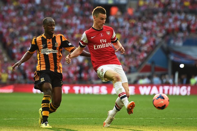 LONDON, ENGLAND - MAY 17: Laurent Koscielny of Arsenal clears the ball from Sone Aluko of Hull City during the FA Cup with Budweiser Final match between Arsenal and Hull City at Wembley Stadium on May 17, 2014 in London, England. (Photo by Shaun Botterill/Getty Images) LONDON, ENGLAND - MAY 17: Laurent Koscielny of Arsenal clears the ball from Sone Aluko of Hull City during the FA Cup with Budweiser Final match between Arsenal and Hull City at Wembley Stadium on May 17, 2014 in London, England. (Photo by Shaun Botterill/Getty Images)