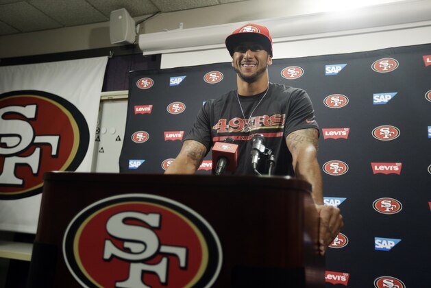 San Francisco 49ers quarterback Colin Kaepernick smiles as he answers question during an NFL football press conference on Wednesday, June 4, 2014, in Santa Clara, Calif. Kaepernick received a new six-year contract extension Wednesday that keeps him with the franchise through the 2020 season. (AP Photo/Marcio Jose Sanchez)