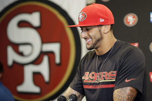San Francisco 49ers quarterback Colin Kaepernick smiles as he answers question during an NFL football press conference on Wednesday, June 4, 2014, in Santa Clara, Calif. Kaepernick received a new six-year contract extension Wednesday that keeps him with the franchise through the 2020 season. (AP Photo/Marcio Jose Sanchez)