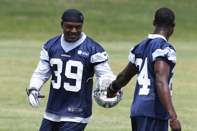 Jun 12, 2012; Irving, TX, USA; Dallas Cowboys cornerback Morris Claiborne (24) hands Brandon Carr (39) his helmet during minicamp at Dallas Cowboys headquarters.  Mandatory Credit: Matthew Emmons-USA TODAY Sports