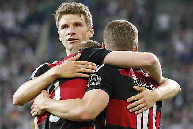 Germany's Thomas Mueller\, from left, Germany's Andre Schuerrle\ and Germany's Lukas Podoslki celebrate scoring during a friendly WCup preparation soccer match between Germany and Cameroon in Moenchengladbach, Germany, Monday, June 2, 2014. (AP Photo/Frank Augstein)