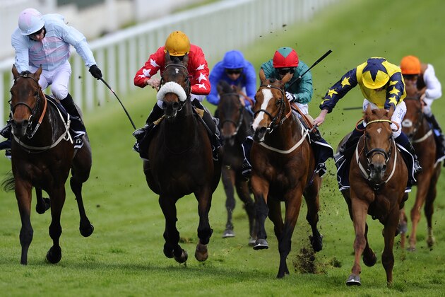 EPSOM, ENGLAND - APRIL 23:  Ryan Moore riding Our Channel (R, blue&yellow) win The Investec Derby Trial at Epsom racecourse on April 23, 2014 in Epsom, England. (Photo by Alan Crowhurst/Getty Images)