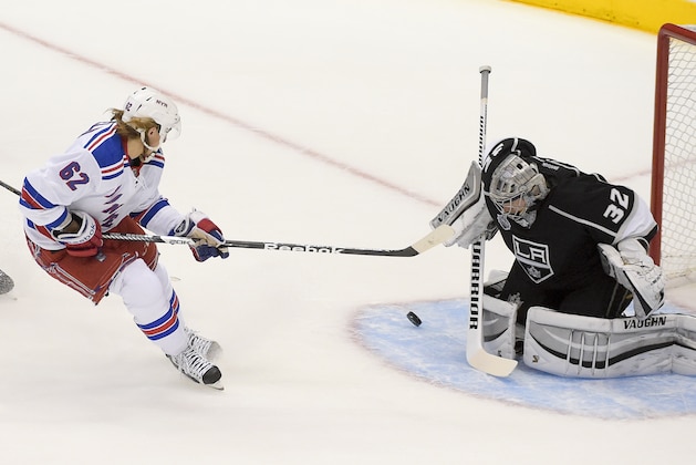 New York Rangers left wing Carl Hagelin, of Sweden, scores past Los Angeles Kings goalie Jonathan Quick  during the first period in Game 1 of the NHL hockey Stanley Cup Finals, Wednesday, June 4, 2014, in Los Angeles. (AP Photo/Mark J. Terrill)