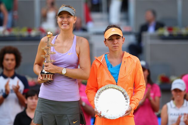 MADRID, SPAIN - MAY 11:  Maria Sharapova of Russia and Simona Halep of Romania hold there winner and runner up trophies after their final match during day nine of the Mutua Madrid Open tennis tournament at the Caja Magica on May 11, 2014 in Madrid, Spain.  (Photo by Clive Brunskill/Getty Images)
