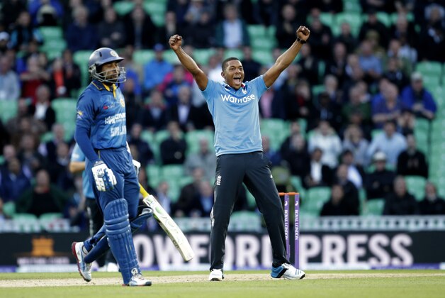 England bowler Chris Jordan celebrates taking the wicket of Sri Lanka's Tillakaratne Dilshan, left, who was caught out by Harry Gurney during the One Day cricket match between England and Sri Lanka at the Oval cricket ground in London, Thursday, May 22, 2014.  (AP Photo/Matt Dunham)
