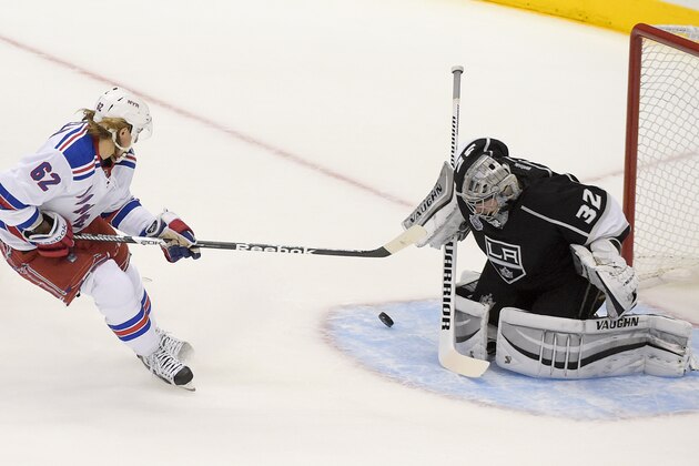 New York Rangers left wing Carl Hagelin, of Sweden, scores past Los Angeles Kings goalie Jonathan Quick  during the first period in Game 1 of the NHL hockey Stanley Cup Finals, Wednesday, June 4, 2014, in Los Angeles. (AP Photo/Mark J. Terrill)
