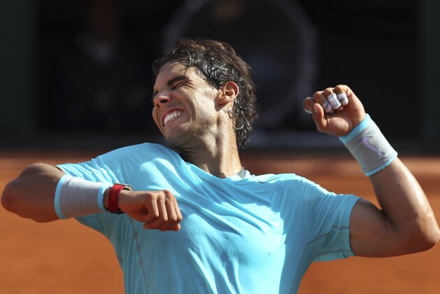 Spain's Rafael Nadal celebrates winning the semifinal match of the French Open tennis tournament against Britain's Andy Murray at the Roland Garros stadium, in Paris, France, Friday, June 6, 2014. Nadal won in three sets 6-3, 6-2, 6-1. (AP Photo/David Vincent)