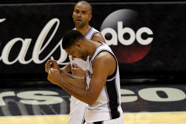 SAN ANTONIO, TX - JUNE 05:  Tim Duncan #21 and Tony Parker #9 of the San Antonio Spurs celebrate after defeating the Miami Heat 110-95 in Game One of the 2014 NBA Finals at the AT&T Center on June 5, 2014 in San Antonio, Texas. NOTE TO USER: User expressly acknowledges and agrees that, by downloading and or using this photograph, User is consenting to the terms and conditions of the Getty Images License Agreement.  (Photo by Chris Covatta/Getty Images)