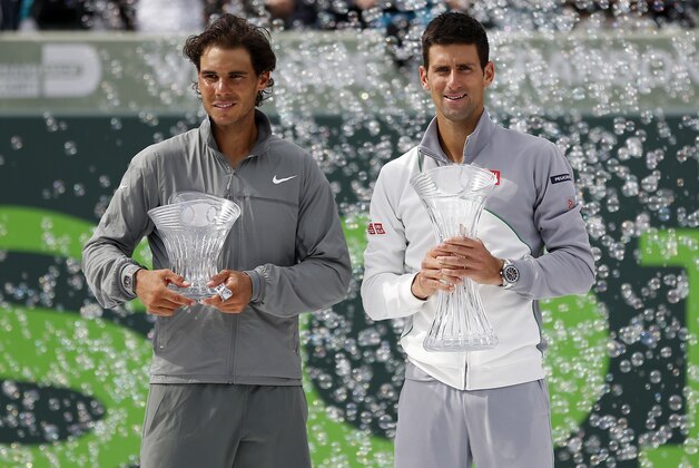 Mar 30, 2014; Miami, FL, USA; Rafael Nadal (L) and Novak Djokovic (R) hold the finalist and championship trophies, respectively, after the men's singles final of the Sony Open at Crandon Tennis Center. Djokovic won 6-3, 6-3. Mandatory Credit: Geoff Burke-USA TODAY Sports
