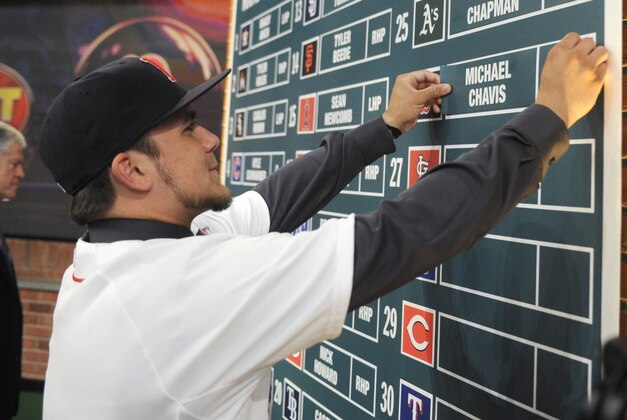 Shortstop Michael Chavis from Sprayberry Senior High School in Marietta, Georgia, posts his name on the board at the 2014 MLB baseball draft Thursday, June 5, 2014, in Secaucus, N.J. Chavis was selected by the Boston Red Sox with the 26th pick in the first round. (AP Photo/Bill Kostroun)