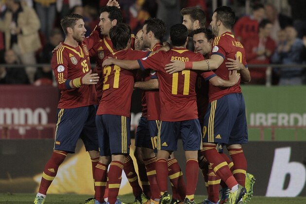 Spain's players celebrate after Xavi Hernandez, 2nd right scored during a 2014 World Cup Group I qualifying soccer match between Spain and Belarus at the  Iberostar Estadi in Palma de Mallorca, Spain, Friday Oct. 11, 2013. (AP Photo/Manu Mielniezuk)