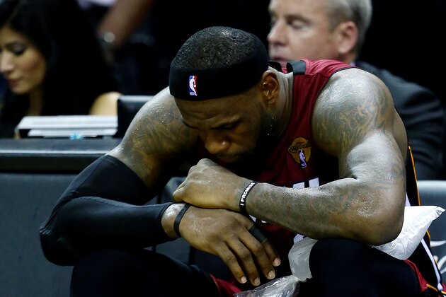 SAN ANTONIO, TX - JUNE 05:  LeBron James #6 of the Miami Heat sits on the bench after leaving the game in the fourth quarter with cramps against the San Antonio Spurs during Game One of the 2014 NBA Finals at the AT&T Center on June 5, 2014 in San Antonio, Texas. NOTE TO USER: User expressly acknowledges and agrees that, by downloading and or using this photograph, User is consenting to the terms and conditions of the Getty Images License Agreement.  (Photo by Andy Lyons/Getty Images)