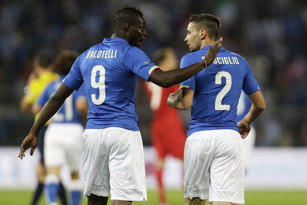 Italy forward Mario Balotelli, left, talks with his teammate defender Mattia De Sciglio during a friendly World Cup preparation soccer match between Italy and Luxembourg in Perugia, Italy, Wednesday, June 4, 2014. Italy opens its World Cup campaign against England in Group D on June 14 then faces Costa Rica on June 20 and Uruguay on June 24. (AP Photo/Luca Bruno)