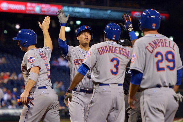 PHILADELPHIA, PA - JUNE 02:  Wilmer Flores #4 of the New York Mets is congratulated by teammates David Wright #5, Curtis Granderson #3 and Eric Campbell #29 after hitting a grand slam home run in the ninth inning against the Philadelphia Phillies at Citizens Bank Park on June 2, 2014 in Philadelphia, Pennsylvania. The Mets won 11-2. (Photo by Drew Hallowell/Getty Images)