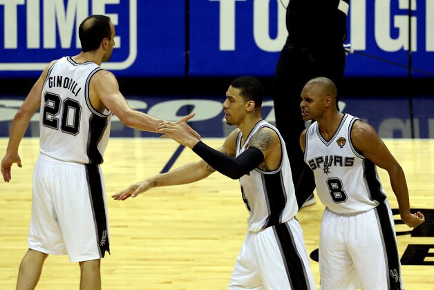SAN ANTONIO, TX - JUNE 05:  Danny Green #4 celebrates with Manu Ginobili #20 and Patty Mills #8 of the San Antonio Spurs against the Miami Heat during Game One of the 2014 NBA Finals at the AT&T Center on June 5, 2014 in San Antonio, Texas. NOTE TO USER: User expressly acknowledges and agrees that, by downloading and or using this photograph, User is consenting to the terms and conditions of the Getty Images License Agreement.  (Photo by Chris Covatta/Getty Images)