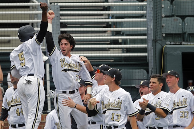 Vanderbilt's Dansby Swanson (7) and Xavier Turner (9) celebrate with teammates after scoring during the first inning of an NCAA college baseball Super Regional tournament game against Stanford Friday, June 6, 2014, in Nashville, Tenn. (AP Photo/Wade Payne)