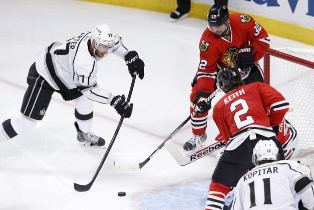 Los Angeles Kings center Jeff Carter shoots, but is unable to score past a defensive wall of Chicago Blackhawks' Michal Rozsival (32)  Corey Crawford and Duncan Keith, during the third period of Game 1 of the Western Conference finals in the NHL hockey Stanley Cup playoffs in Chicago. The Blackhawks' defense is playing a key role in this postseason run as the Kings found out how hard it is to score on the defending Stanley Cup champions. (AP Photo/Charles Rex Arbogast)
