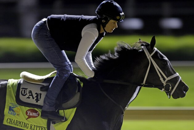 Exercise rider Patti Krotenko rides Kentucky Derby entrant Charming Kitten for a workout at Churchill Downs Friday, May 3, 2013, in Louisville, Ky. Saturday will be the 139th running of the Kentucky Derby. (AP Photo/David Goldman)