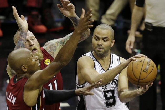 San Antonio Spurs guard Tony Parker (9) tries to pass around Miami Heat guard Ray Allen, left, and forward Chris Andersen (11) during the second half in Game 1 of the NBA basketball finals on Thursday, June 5, 2014 in San Antonio. (AP Photo/Tony Gutierrez)