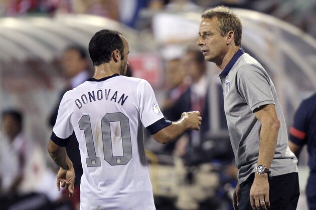 In this photo taken Tuesday, Sept. 10, 2013, United States manager Jurgen Klinsmann, right, talks with Landon Donovan during a World Cup qualifying soccer match against Mexico in Columbus, Ohio. The United States clinched its seventh straight World Cup appearance, getting second-half goals from Eddie Johnson and Donovan on Tuesday night in a 2-0 win over Mexico.(AP Photo/Jay LaPrete)