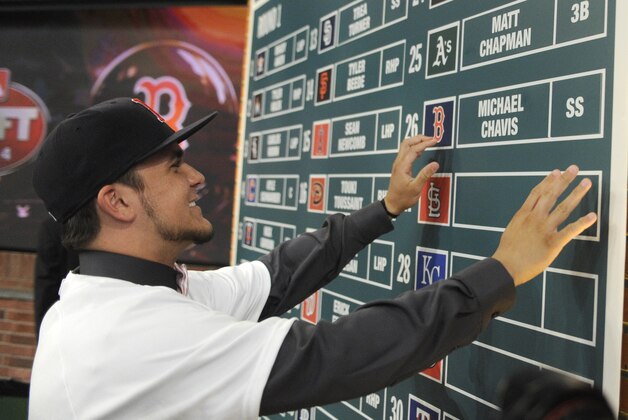 Shortstop Michael Chavis from Sprayberry Senior High School in Marietta, Georgia, posts his name on the board at the 2014 MLB baseball draft Thursday, June 5, 2014, in Secaucus, N.J. Chavis was selected by the Boston Red Sox with the 26th pick in the first round. (AP Photo/Bill Kostroun)
