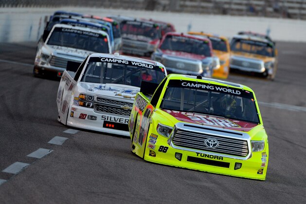FORT WORTH, TX - JUNE 06:  Matt Crafton, driver of the #88 Slim Jim/Menards Toyota, leads a pack of trucks during the NASCAR Camping World Truck Series WinStar World Casino & Resort 400 at Texas Motor Speedway on June 6, 2014 in Fort Worth, Texas.  (Photo by Robert Laberge/Getty Images for Texas Motor Speedway)