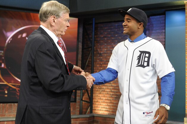Baseball Commissioner Bud Selig, left, shakes hands with outfielder Derek Hill from Elk Grove High School in Sacramento, California, at the 2014 MLB baseball draft Thursday, June 5, 2014, in Secaucus, N.J. Hill was selected by the Detroit Tigers with the 23rd pick in the first round. (AP Photo/Bill Kostroun)