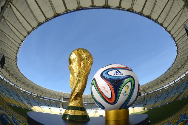 RIO DE JANEIRO, BRAZIL - DECEMBER 03:  A general view of Brazuca and the FIFA World Cup Trophy at the Maracana before the adidas Brazuca launch at Parque Lage on December 3, 2013 in Rio de Janeiro, Brazil. Brazuca is the Official Match Ball for the FIFA World Cup 2014 Brazil. Tonight adidas revealed brazuca to the world in the stunning setting of Parque Lage in Rio de Janeiro. The reveal was part of a spectacular light projection supported by global footballers Seedorf, Hernane and FIFA World Cup Winner Cafu. Hundreds of guests and celebrities were treated to this one off experience, which launched the Official FIFA World Cup Ball for Brazil 2014. For more information visit: news.adidas.com/worldcupOMB  (Photo by Alexandre Loureiro/Getty Images for adidas)