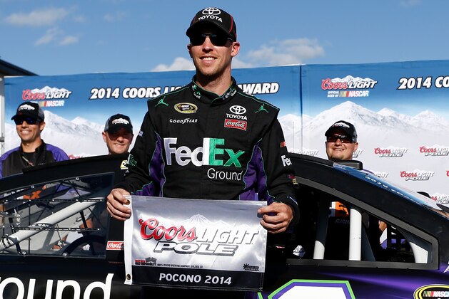 LONG POND, PA - JUNE 06:  Denny Hamlin, driver of the #11 FedEx Ground Toyota, poses with the Coors Light Pole Award after qualifying for the pole during qualifying for the NASCAR Sprint Cup Series Pocono 400 at Pocono Raceway on June 6, 2014 in Long Pond, Pennsylvania.  (Photo by Jeff Zelevansky/Getty Images)