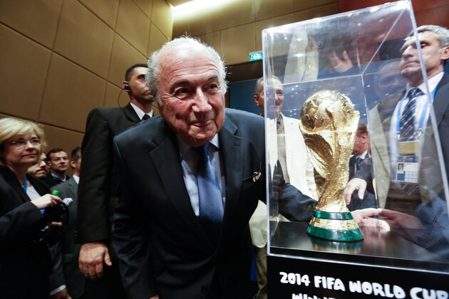 SAO PAULO, BRAZIL - JUNE 05: President of FIFA Joseph Blatter poses beside the World Cup trophy after a press conference following the last session of the Organising Committee for the FIFA World Cup at the Grand Hyatt Hotel on June 5, 2014 in Sao Paulo, Brazil. (Photo by Alexandre Schneider/Getty Images)