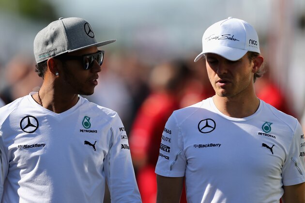 MONTREAL, QC - JUNE 06:  Lewis Hamilton of Great Britain and Mercedes GP and Nico Rosberg of Germany and Mercedes GP walk across the paddock during practice ahead of the Canadian Formula One Grand Prix at Circuit Gilles Villeneuve on June 6, 2014 in Montreal, Canada.  (Photo by Mathias Kniepeiss/Getty Images)