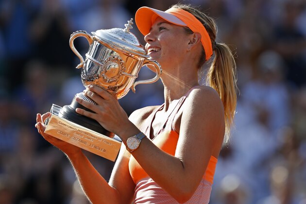 Russia's Maria Sharapova holds the trophy after winning the final of the French Open tennis tournament against Romania's Simona Halep at the Roland Garros stadium, in Paris, France, Saturday, June 7, 2014. Sharapova won in three sets 6-4, 6-7, 6-4. (AP Photo/Darko Vojinovic)