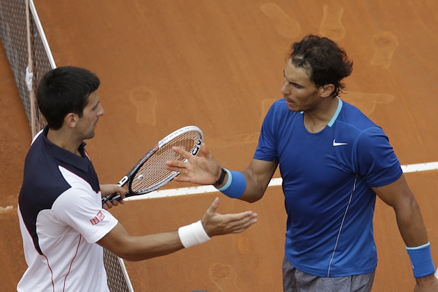 Serbia's Novak Djokovic, left, congratulates Spain's Rafael Nadal after winning the final match at the Italian open tennis tournament in Rome, Sunday, May 18, 2014. Novak Djokovic extended his recent dominance over Rafael Nadal by rallying for a 4-6, 6-3, 6-3 victory Sunday to win the Italian Open for the third time. (AP Photo/Gregorio Borgia)