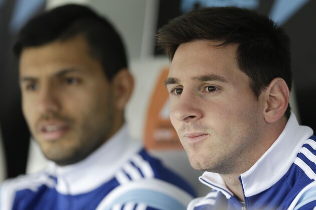 Argentina's Lionel Messi, right, and Sergio Aguero sit on the bench before an international friendly soccer match against Slovenia in La Plata, Argentina, Saturday, June 7, 2014. Argentina is leaving June 9 for Brazil to compete in the World Cup. (AP Photo/Natacha Pisarenko)