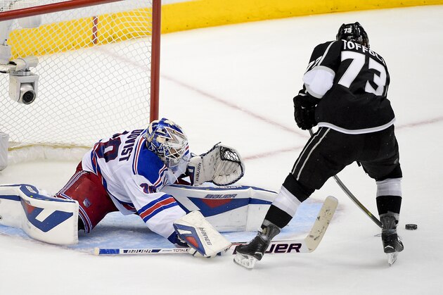 New York Rangers goalie Henrik Lundqvist, of Sweden, left, blocks a shot by Los Angeles Kings center Tyler Toffoli during the third period in Game 1 of the NHL hockey Stanley Cup Finals, Wednesday, June 4, 2014, in Los Angeles. (AP Photo/Mark J. Terrill)