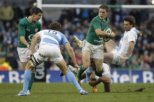 Ireland's Craig Gilroy, center, is tackled by Argentina's Nicolas Sanchez, and Marcelo Bosch, right, as Ireland's Jonathan Sexton, left, follows play during their Rugby Union International at the Aviva Stadium, Dublin, Ireland, Saturday, Nov. 24, 2012.  (AP Photo/Peter Morrison)
