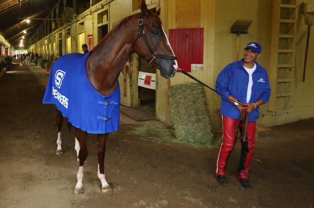 ELMONT, NY - JUNE 05:  Kentucky Derby and Preakness winner California Chrome, with exercise rider Willie Delgado walks outside his stall after training on the main track at Belmont Park on June 5, 2014  in Elmont,  New York   He is scheduled to race for the Triple Crown in the 146th running of the Belmont Stakes  (Photo by Al Bello/Getty Images)
