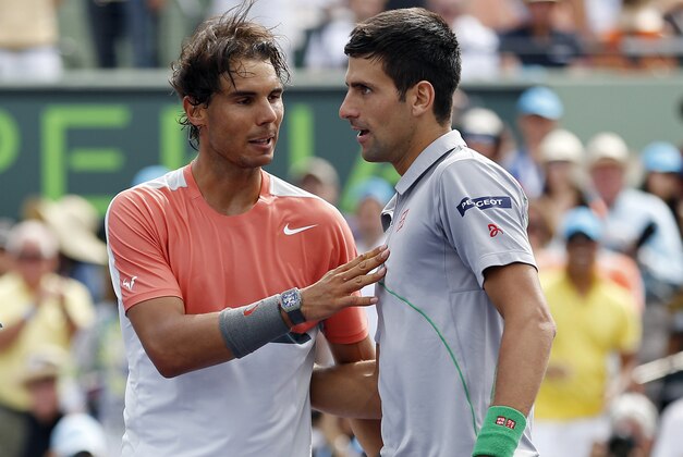 Mar 30, 2014; Miami, FL, USA; Novak Djokovic (right) shakes hands with Rafael Nadal (left) after winning the men's singles final of the Sony Open at Crandon Tennis Center. Djokovic won 6-3, 6-3. Mandatory Credit: Geoff Burke-USA TODAY Sports