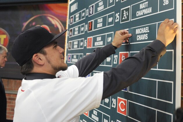 Shortstop Michael Chavis from Sprayberry Senior High School in Marietta, Georgia, posts his name on the board at the 2014 MLB baseball draft Thursday, June 5, 2014, in Secaucus, N.J. Chavis was selected by the Boston Red Sox with the 26th pick in the first round. (AP Photo/Bill Kostroun)