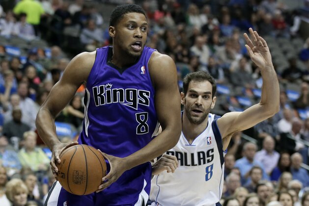 Sacramento Kings' Rudy Gay (8) drives past Dallas Mavericks' Jose Calderon (8) in the first half of an NBA basketball game, Friday, Jan. 31, 2014, in Dallas. (AP Photo/Tony Gutierrez)