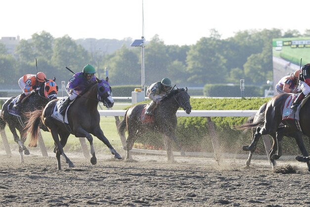 Tonalist, second from right, with Joel Rosario up, goes nose to nose with Commissioner, right, with Javier Castellano up, as California Chrome, second from left, with Victor Espinoza up, lags behind during the 146th running of the Belmont Stakes horse race, Saturday, June 7, 2014, in Elmont, N.Y. Tonalist won the race with Commisioner coming in second. (AP Photo/Peter Morgan)